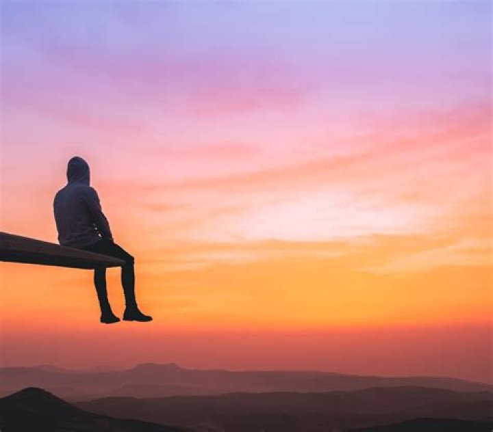 A person watching a sunset