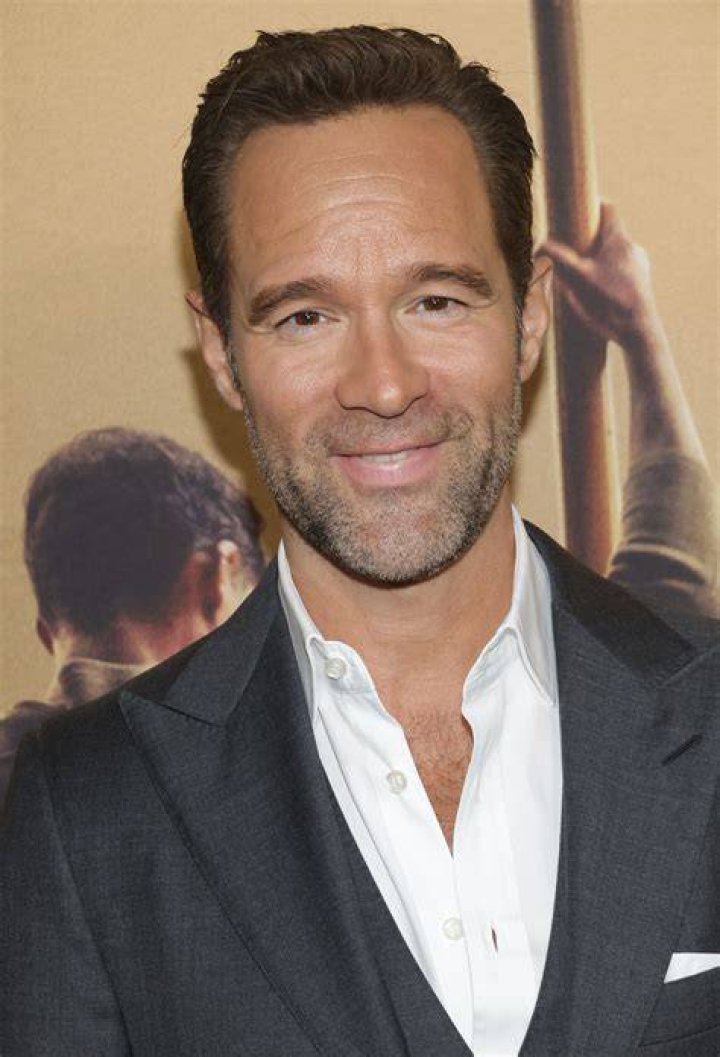Chris Diamantopoulos smiling in a picture alongside Debra Messing at the Vanity Fair kickoff part for the 2009 Tribeca Film Festival