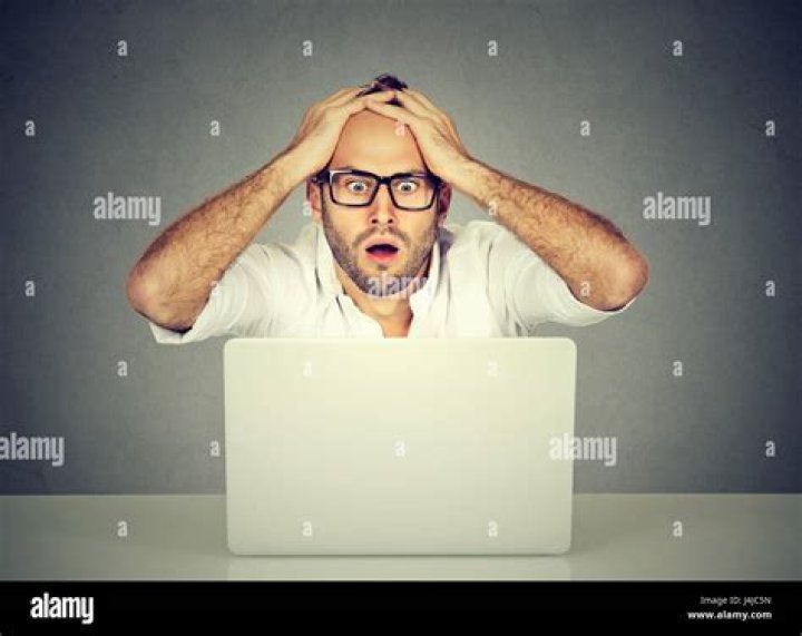 man looking at computer shocked