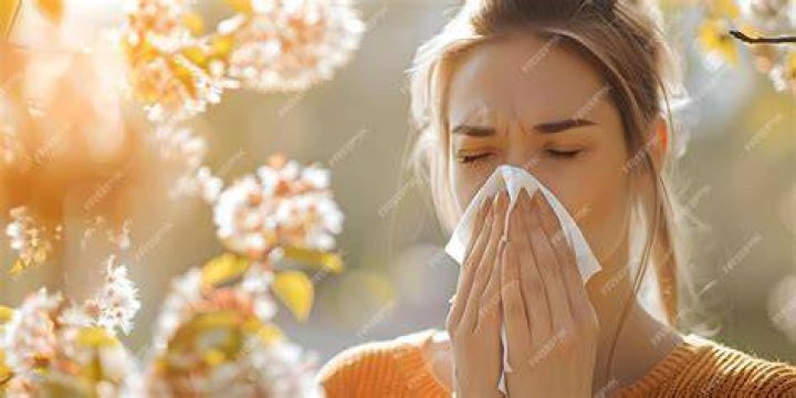 woman sneezing from allergies