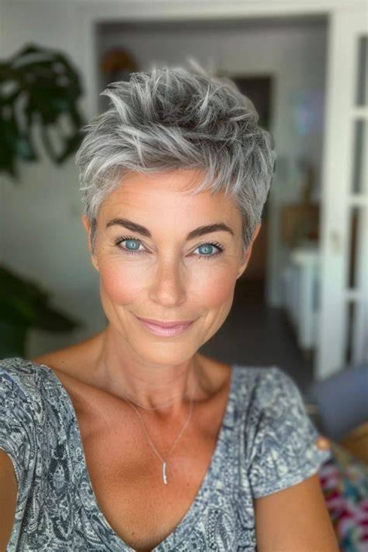 Woman with short gray hair shopping for sneakers in a store