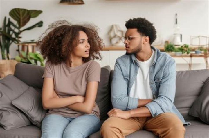 Young couple with relationship problems arguing at home.